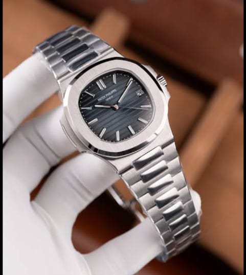 Patek Philippe Nautilus watch specifically the stainless steel, featuring a blue-black gradient dial