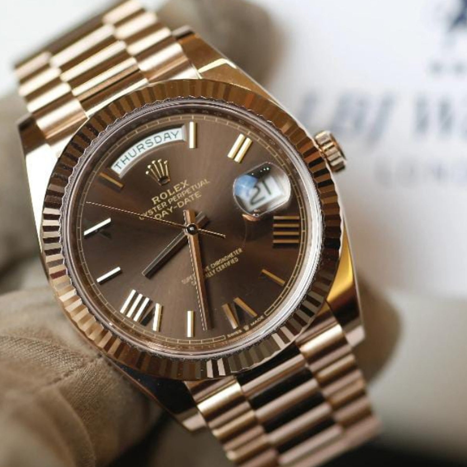 This is a Rolex Oyster Perpetual Day-Date Oyster Perpetual Day Date  with a chocolate dial, fluted bezel, and President bracelet.