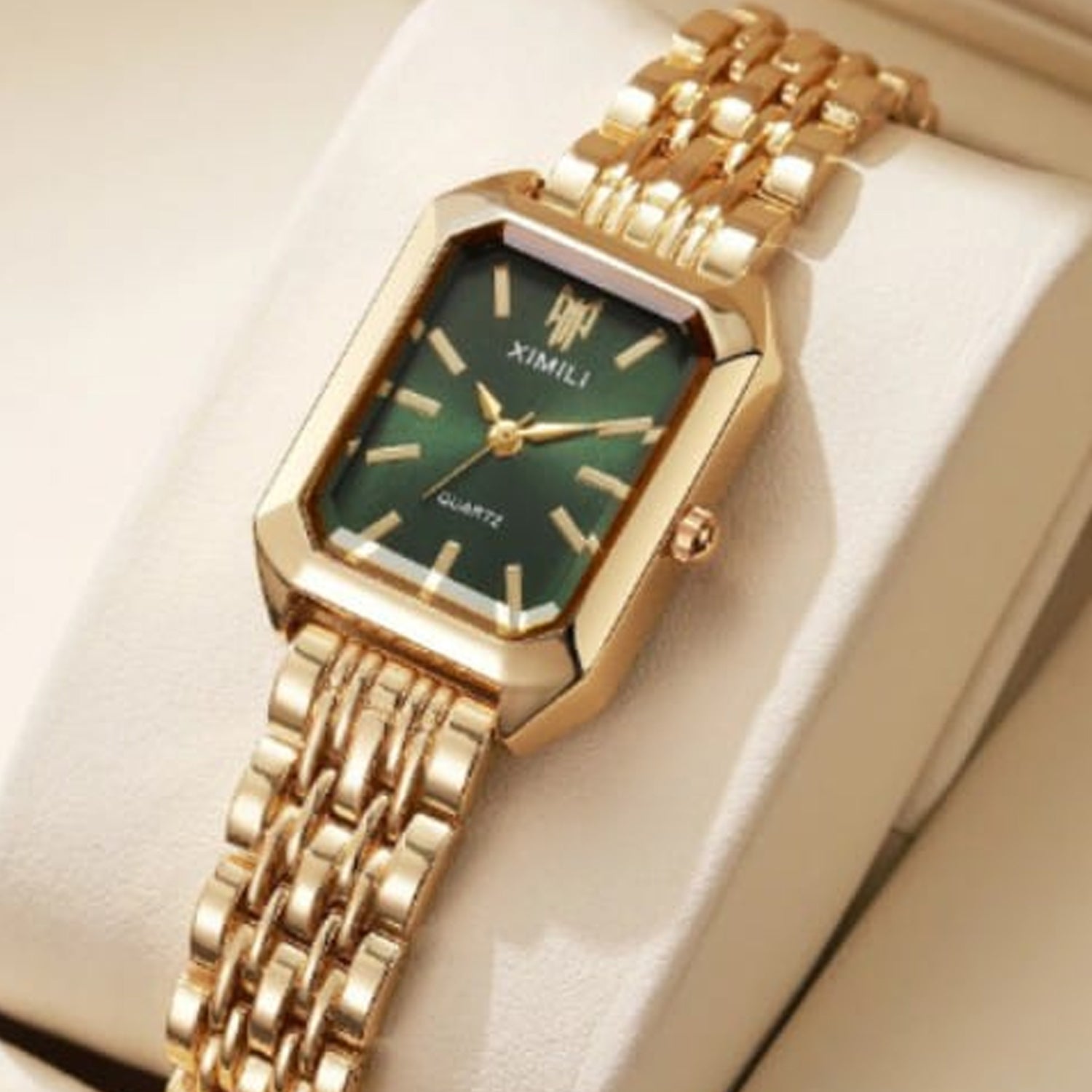 fashionable luxury quartz wristwatch Ximili Quartz gold watch features a rectangular case with a green dial and a matching gold-tone steel bracelet.
