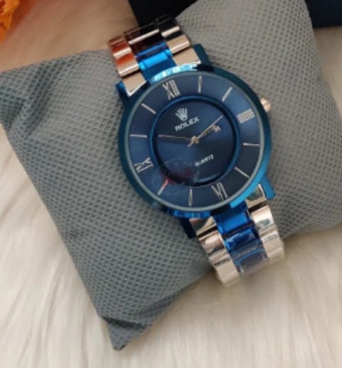 Rolex Gents SLM (BL), featuring a distinct royal blue dial and a matching blue and silver chain strap.