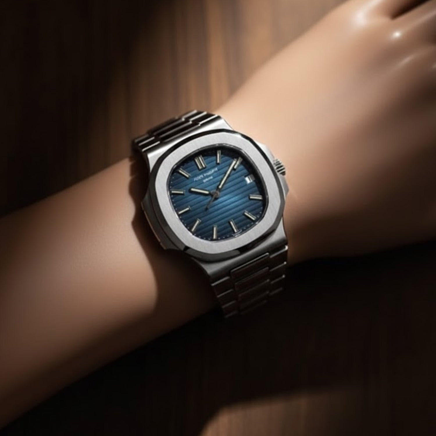 Patek Philippe Nautilus watch specifically the stainless steel, featuring a blue-black gradient dial