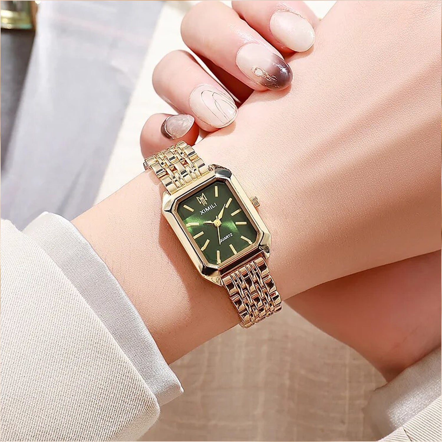 fashionable luxury quartz wristwatch Ximili Quartz gold watch features a rectangular case with a green dial and a matching gold-tone steel bracelet.