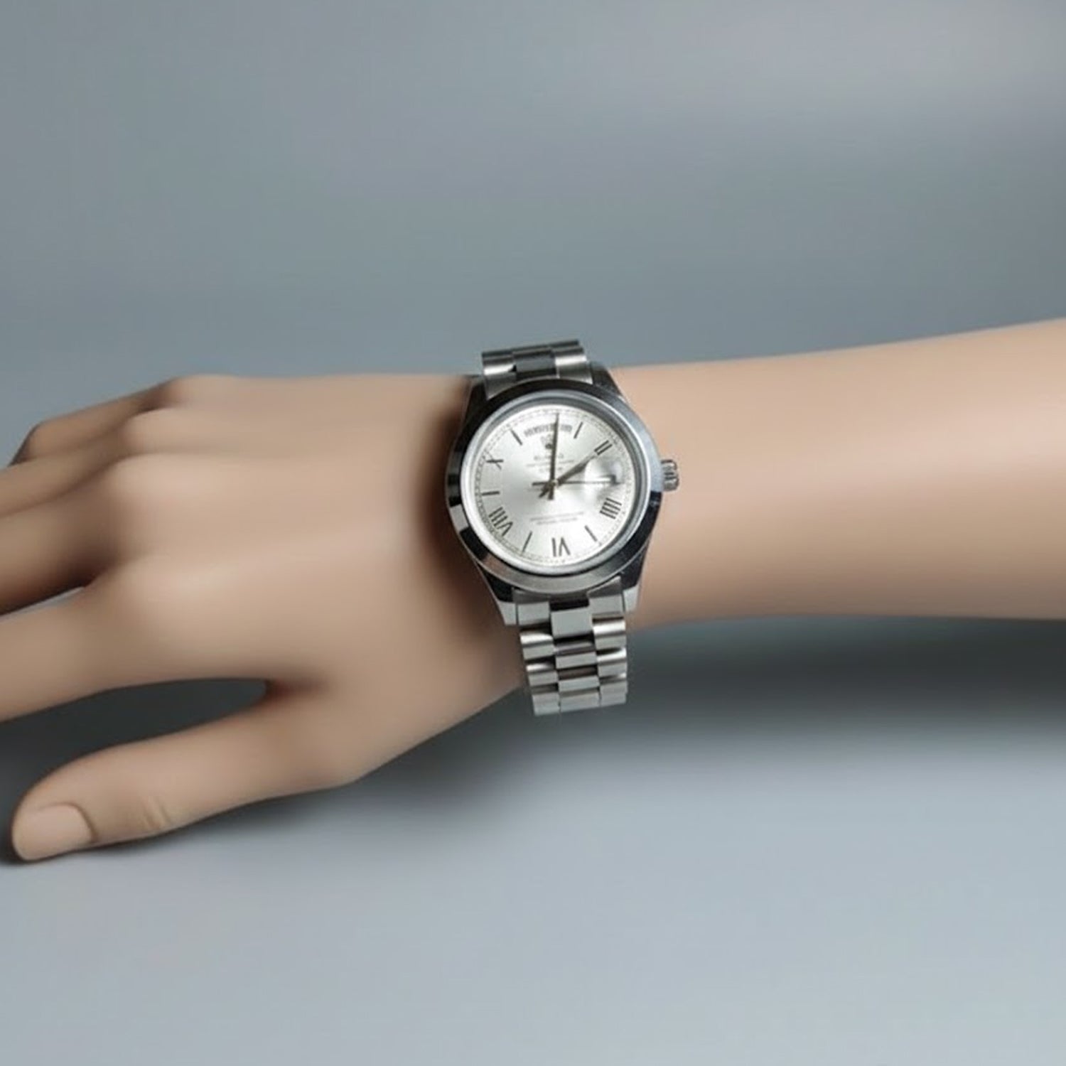 Rolex Day-Date is a luxury timepiece featuring a silver dial with Roman numerals and a matching silver stainless steel bracelet.